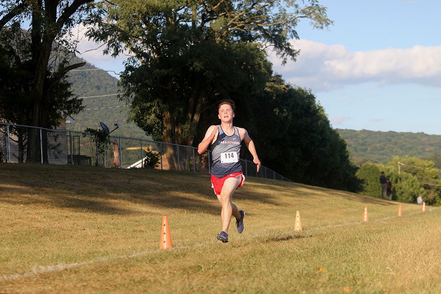 Junior Hayden Kirwan crosses the finish line with a time of 18:07, placing him 6th in the boys varsity race.