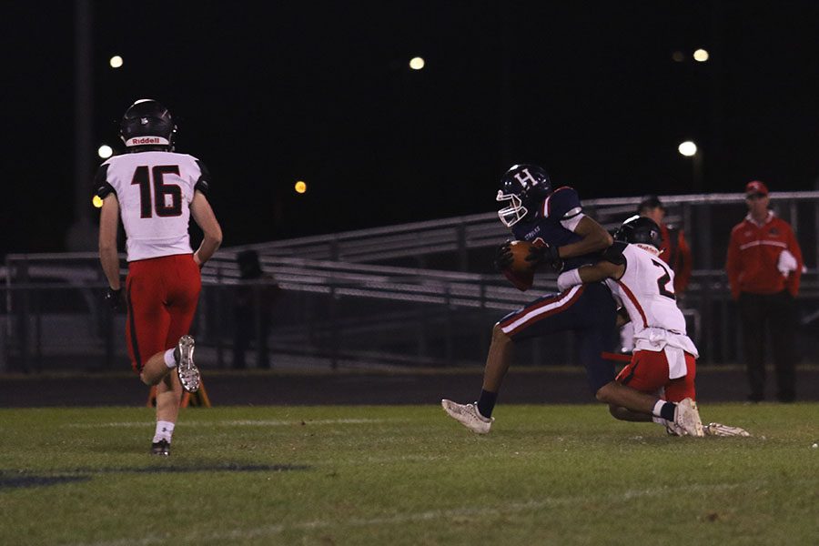 Senior wide receiver Malachi Davis (#3)  gets tackled during a pass play. The Streaks offense scored one touchdown during the game against Sherando.