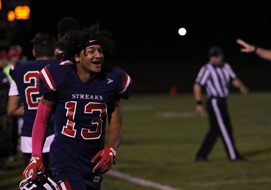 Junior Isaiah Hamilton (#13) celebrates after a first down by the Streaks offense.