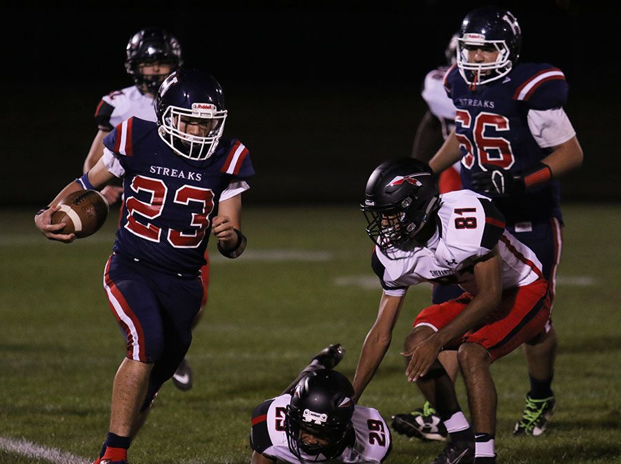 Junior Xander Collazo (#23) runs for a first down during the fourth quarter. HHS lost to Sherando 7-52.