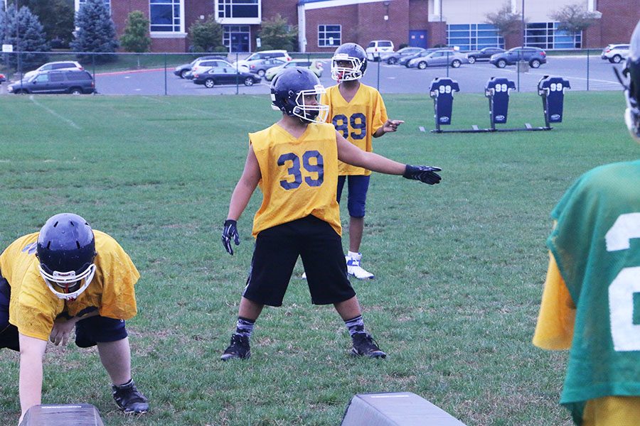 As captain of the defense, Bryson Moats directs lineman to their position for run throughs. 