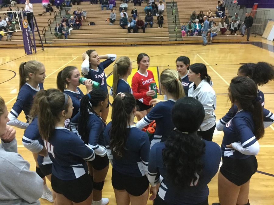 The varsity volleyball team huddles up in a time out during their game at Waynesboro Oct. 17. 