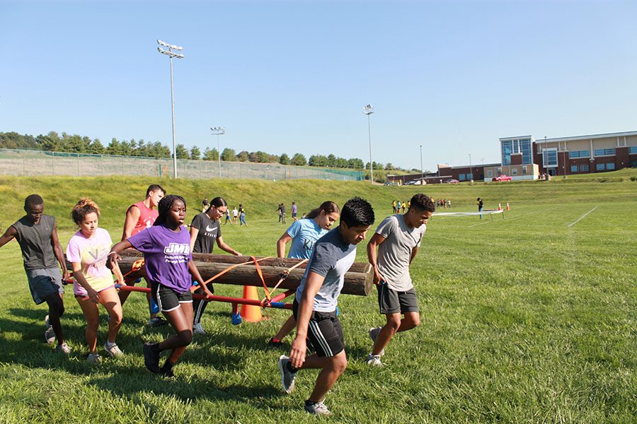 A team carries logs for the team physical fitness course. 