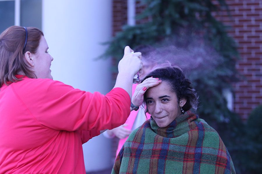 Senior Alyce Kilby-Woodward gets her hair dyed pink at the Red Sea tailgate prior to the pink out football game.