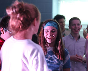 Senior Kate Cummings laughs while she talks to her friends.
