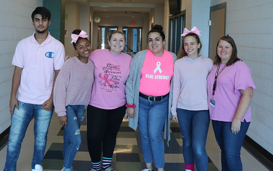 Julie Tibbles and a group of her students all wear pink to support breast cancer awareness.