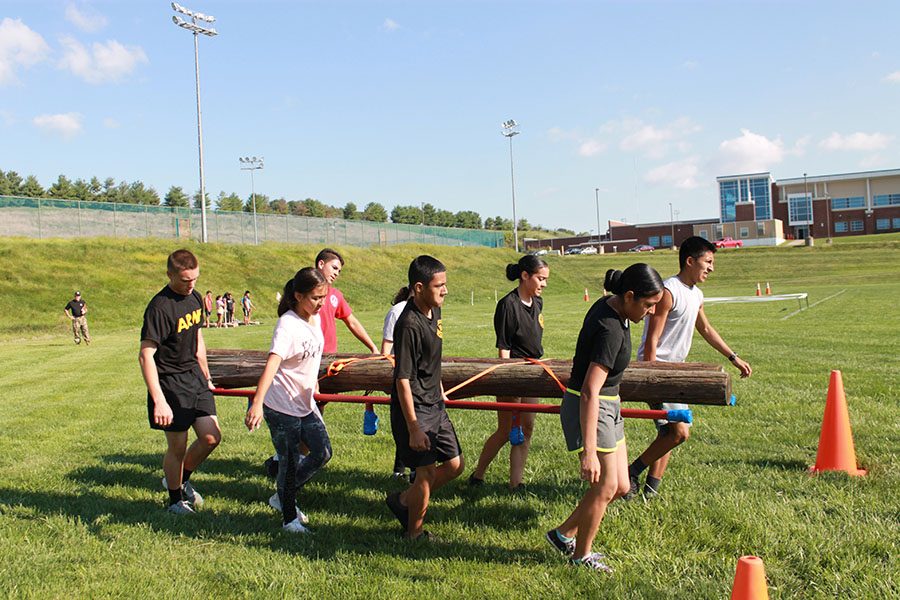 B team carries logs for the team physical fitness course.