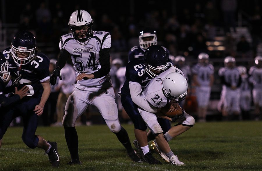 Freshman linebacker Bryson Moats tackles the ball carrier of the Turner Ashby Knights.