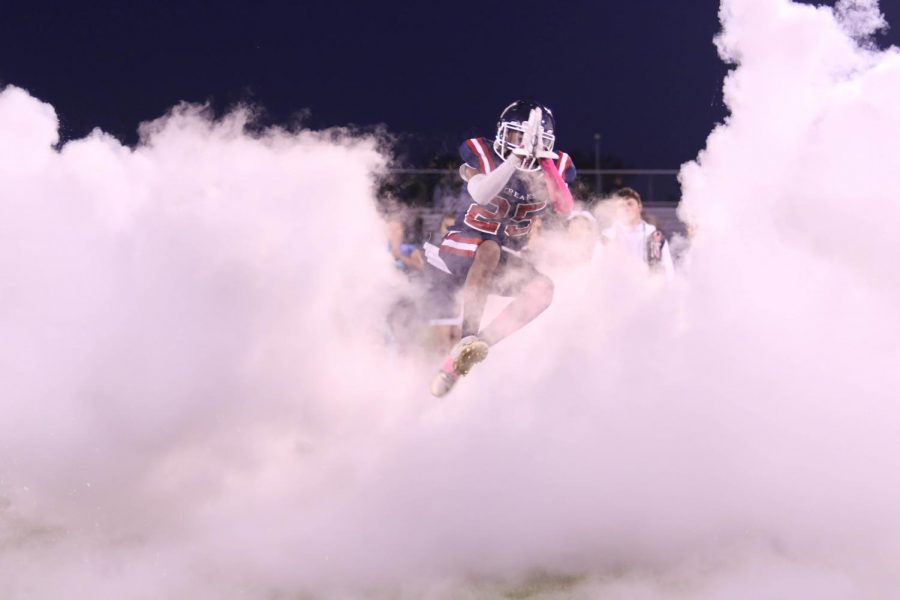 Junior Marquez Sly jumps through the smoke prior to the Streaks home game versus Broadway.