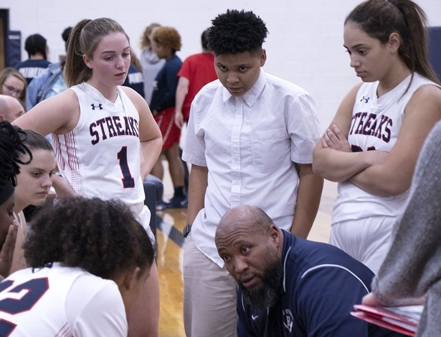 Coach+Durmount+Perry+talks+to++the+girls+basketball+team+during+a+timeout.