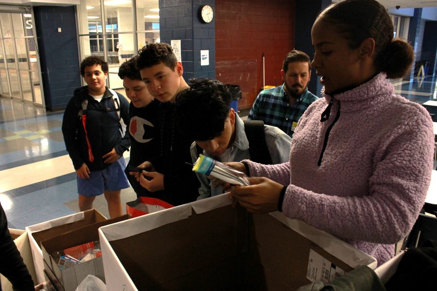 Freshman Alisha Moyd sorts items donated by students and staff to put in holiday bags to give to the homeless. Moyd believes in the importance of giving back and looks forward to future community service projects through TOP. “This is to help the community. We do a lot of things to help the community and we just started, Moyd said. 
