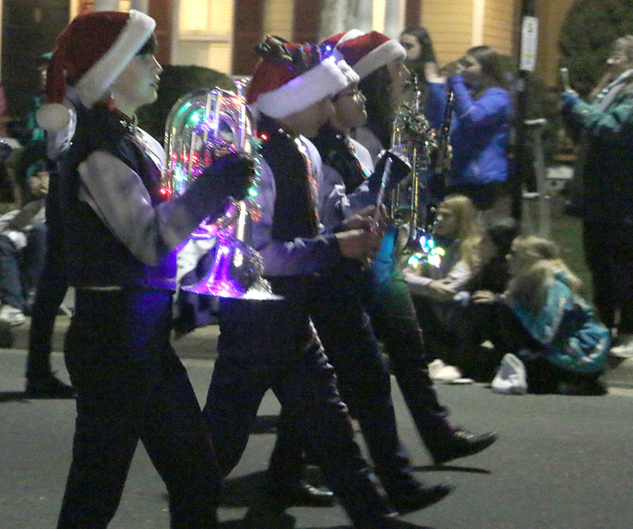 The band progresses down into the parade with their decorated instruments. 