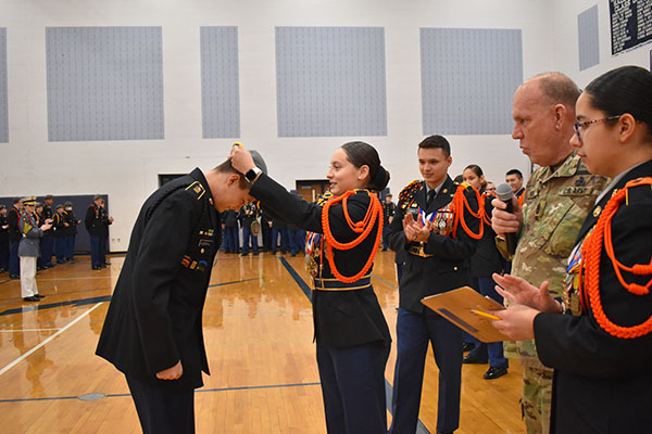Senior Amy Acosta Cruz gives out an award to a cadet who won knock out in drill. 