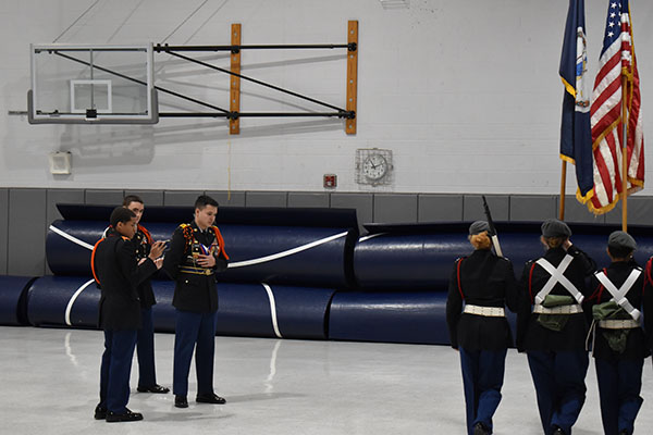 Senior Melvin Chicas grades the color guard of another school.