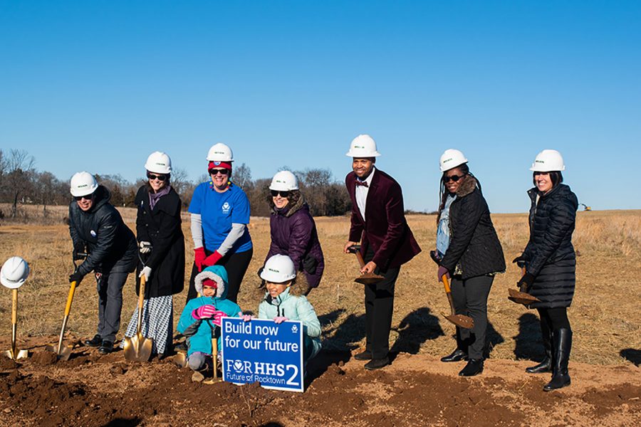 Representatives of the For HHS2 group dig into the ground at the new site. Members of the community and city council attended the event to celebrate the start of the construction of the new high school. 