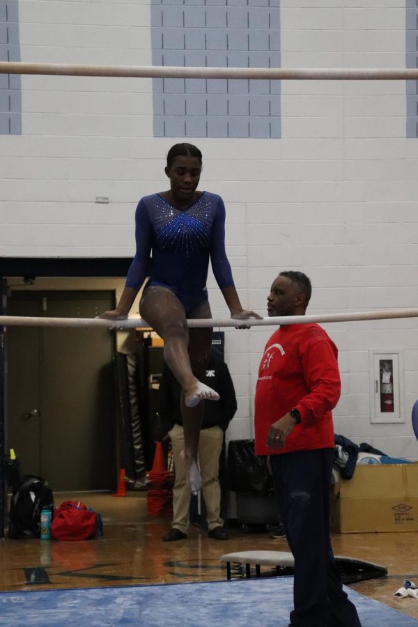Freshman Denajah Hepner prepares to do a mill circle on the low bar during her routine. 