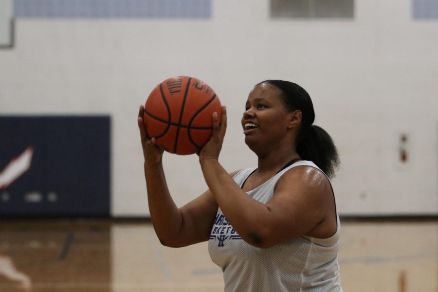 During a shooting drill, junior Nisha Farmer practices her form. 