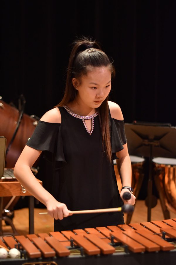 Sophomore Jeslyn Liu plays the Marimba during a percussion band concert. 