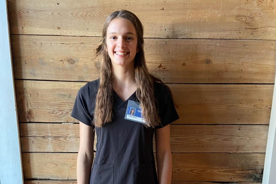 Junior Isabel Campillo wears her scrubs and student ID as part of her uniform for her mentorship at Sentara Rockingham Memorial Hospital. 