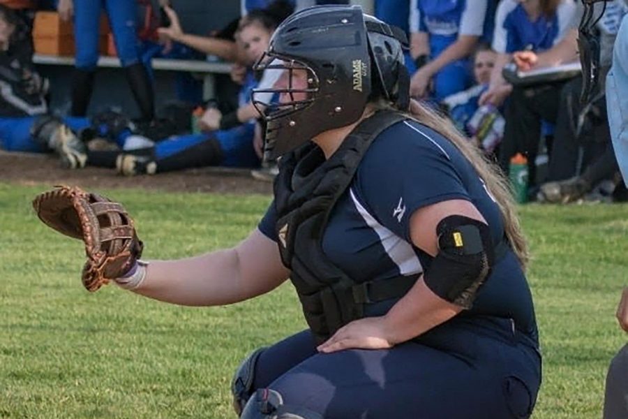 Sophomore Brianna Knupp plays catcher in one of her softball games. Although her injury prevents her from playing, Knupp still has hopes to be a part of the team by being a manager for the Varsity Softball team at HHS.