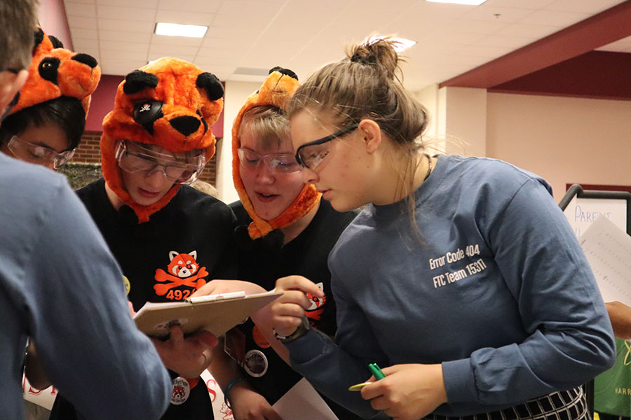 Junior Eva Velker speaks to another team about their robot. 