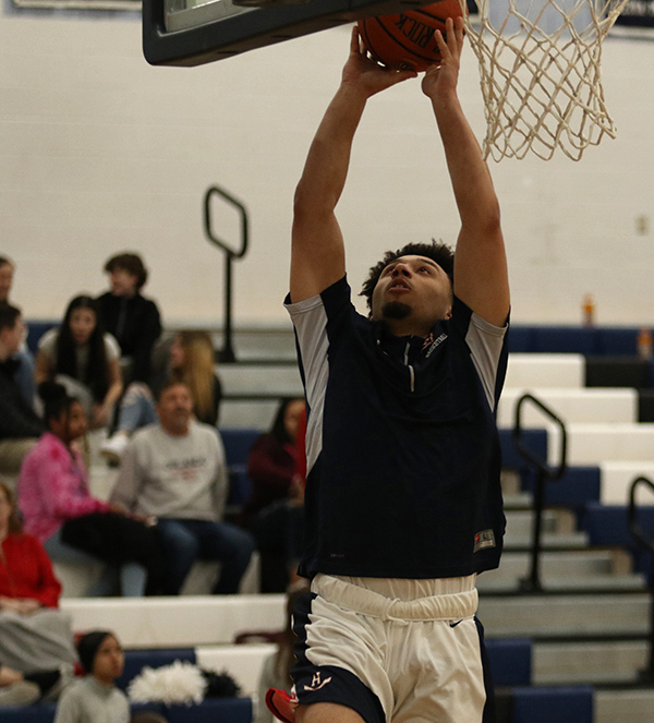 During warm-ups, senior DShawn Fields attempts a lay up.