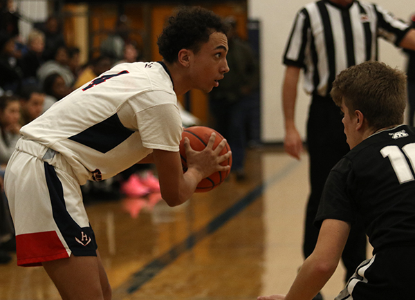 Senior Tre Butler holds the ball on the 3-point line after receiving a pass. 