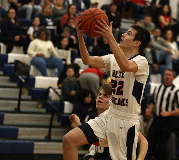 Junior Jesse Lichti goes for a lay-up during the 3rd period of the game.