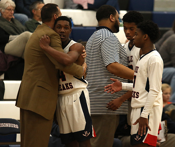 Coach Don Burgess embraces Senior Shamond Megginson after being substituted out during the last minutes of the game.