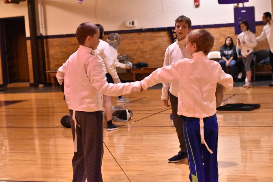 The fencing students shake hands after a long, brutal match. 