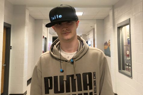 Sophomore Michel Blancher displays his light up hat with ''Smile'' on it.