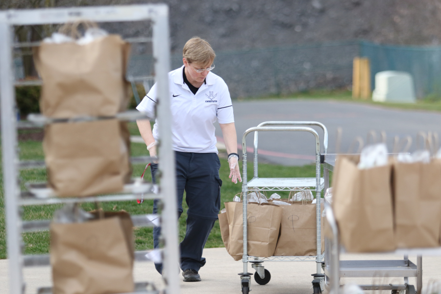 HHS principal Melissa Hensley rolls bagged food to give to families during the COVID-19 lockdown.