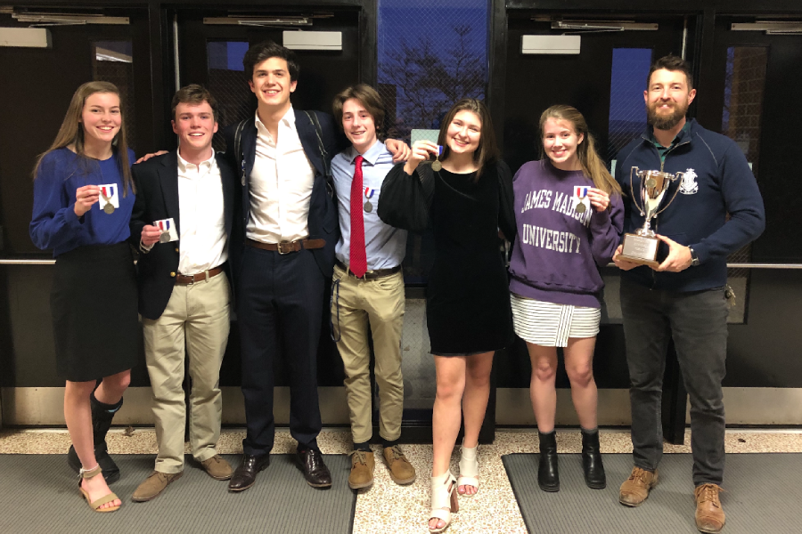 The HHS debate team stands holding their medals alongside coach Aaron Cosner after their regionals competition. The competition was held at Turner Ashby High School. 