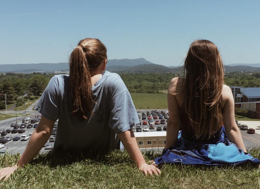 (Right to Left) Seniors Kate Cummings and Lily Gusler gaze across the school parking lot during a Fine Arts Learning Community activity during their freshman year 2016-2017.