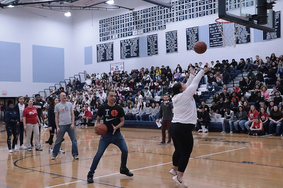 Senior Tre Butler and athletic trainer Siaura Seville play knock out during the pep rally.