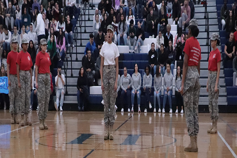 Students apart of the JROTC step team perform their step routine during the pep rally.