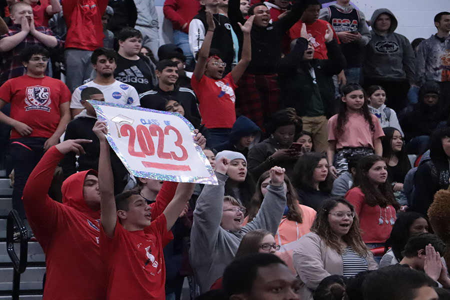 Freshman Jadon Burgess holds the sign and takes part of cheering with the freshman. 