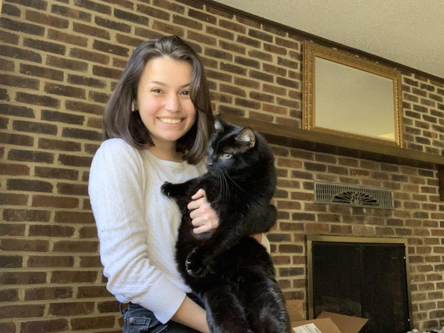 Sophomore Ilana Mattson holds her cat, Merlin. “I haven’t really spent that much more time with my cats, but I have been sleeping downstairs which is where the cats typically hang out. They’ll come in and I’ll get to sleep with them at my feet and that’s really cute,” Mattson said. 
