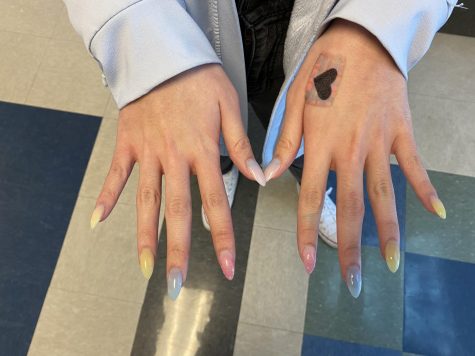 Junior Emily Nguyen enjoys different colored nails like this set. She likes to be creative and enjoys the way acrylics make her feel more confident about herself.