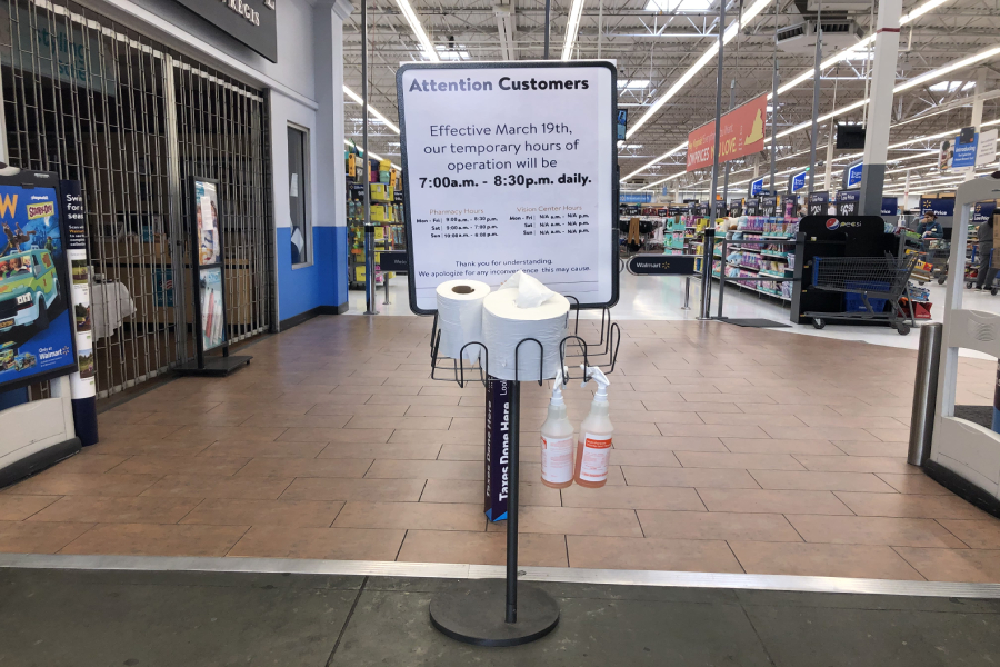 Upon entering Walmart, signs with new hours has been posted with cleaning supplies for the employees. In addition to this, there are hand sanitizer dispensers at the entrance as well.  