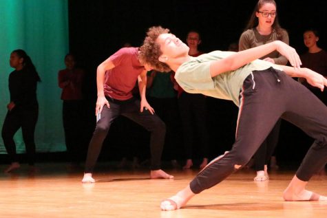Junior Javion Green dances on stage in the auditorium. Green's favorite type of dance is modern.