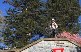 Freshman Palmer Hall stands at the top of the staircase after riding up Campbell Street in Harrisonburg on his bike. 