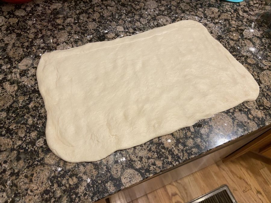 After rising, roll the dough into a large rectangle and fold into thirds. Then wrap in plastic wrap and chill; to achieve the iconic layers of a classic croissant, the dough must be kept cold at all times.
