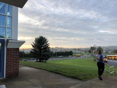 Buses pull up to the school for early morning drop off.