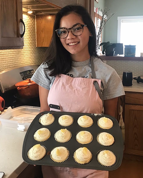 Junior Sophia Yoder shows off fresh newly baked cupcakes in her spare time. “Baking is something I do to de-stress, and it’s also just a fun hobby. I figured selling the things I bake would be a great way to both do something that I love as well as help raise money for charities,” Yoder said. 