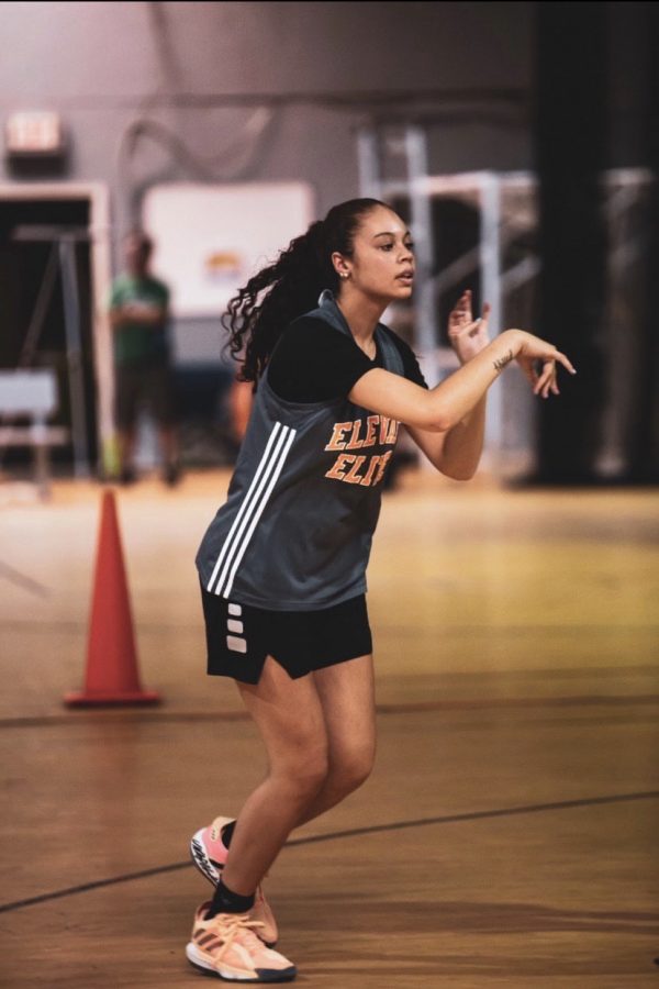 Cain looks to pass the ball during a practice for the team she plays on outside of school, Elevate Elite. 