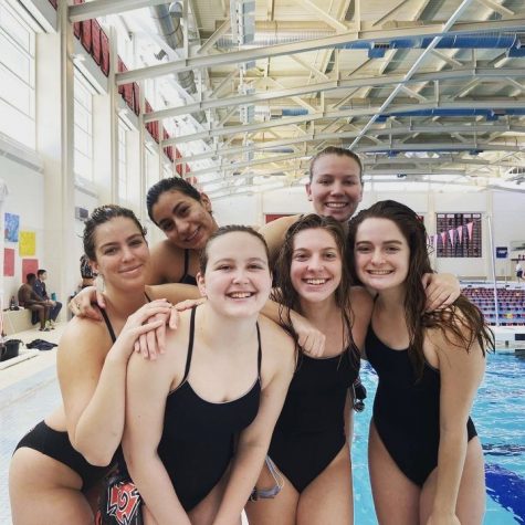 Fox (second from right) with her teammates during a swim meet. 