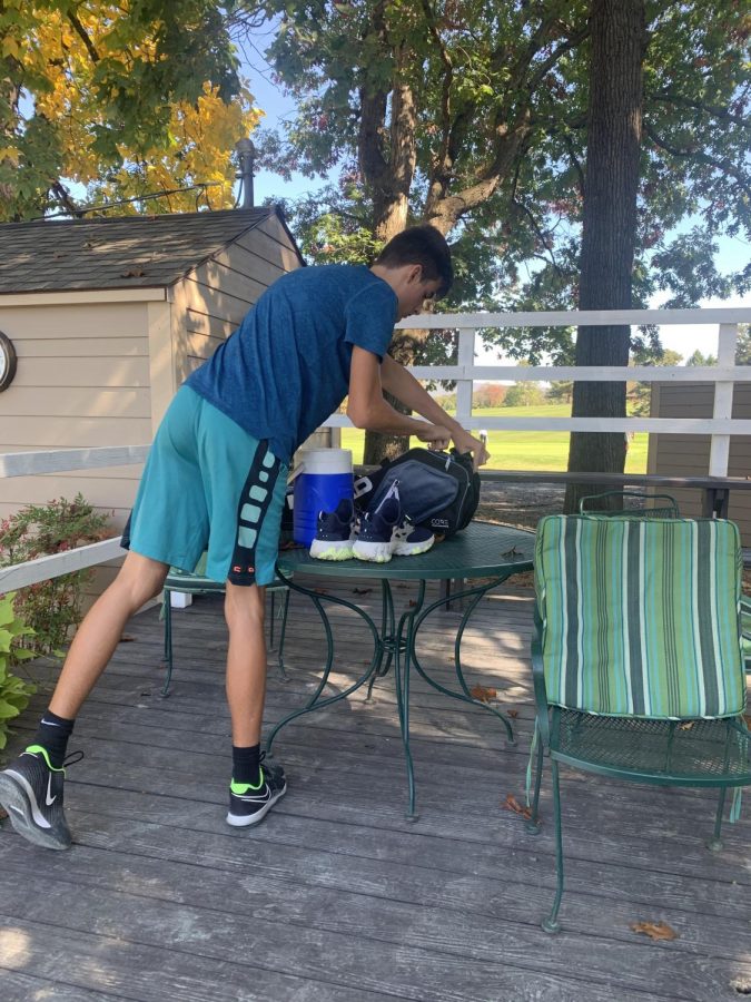 Kyle gets prepared to play tennis. 