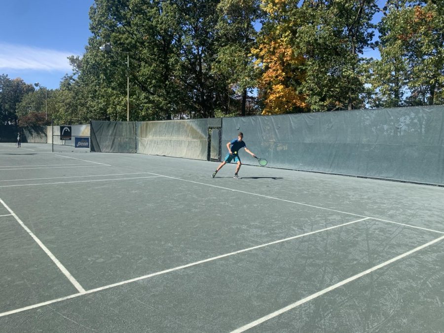 William Kyle, playing tennis with his instructor. 