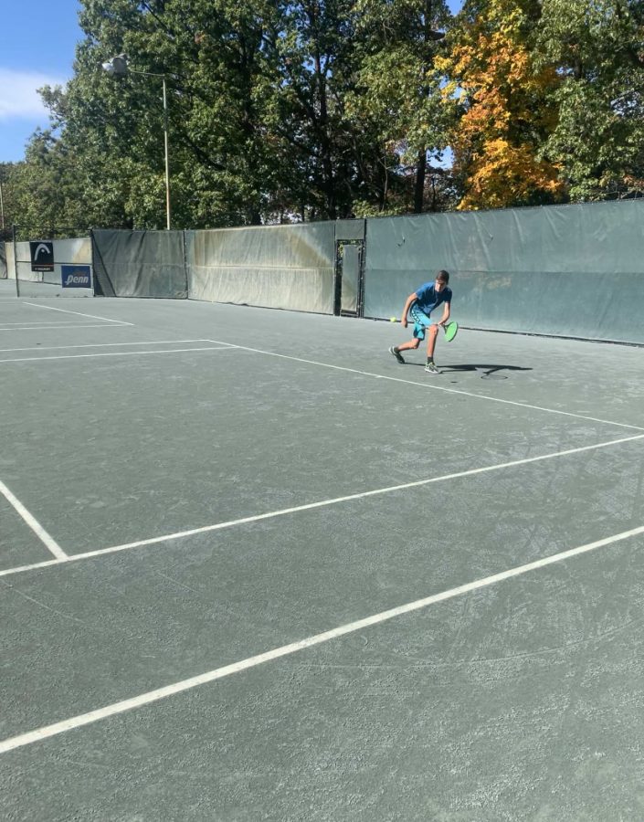 Getting low to hit the ball. 